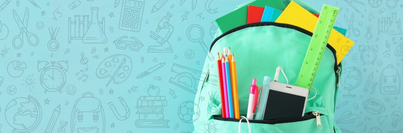 Green backpack with school supplies sticking out of the pockets. Pencils, ruler, notebooks. 