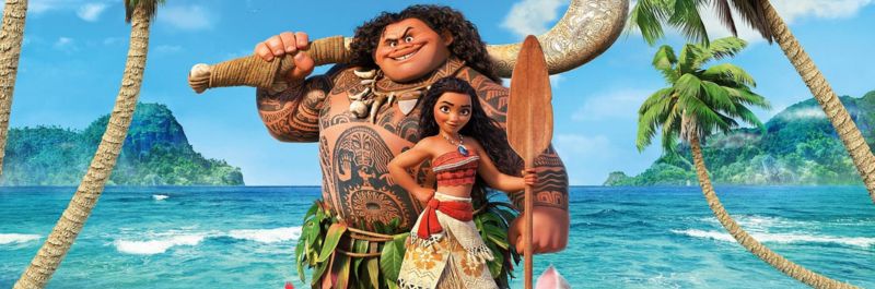 Disney's Moana and Maui standing with ocean behind them. Both are holding canoe paddles and palm trees are around them.