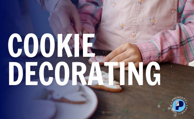 An adult skillfully decorates cookies with a child, surrounded by a plate of frosted and decorated cookies.