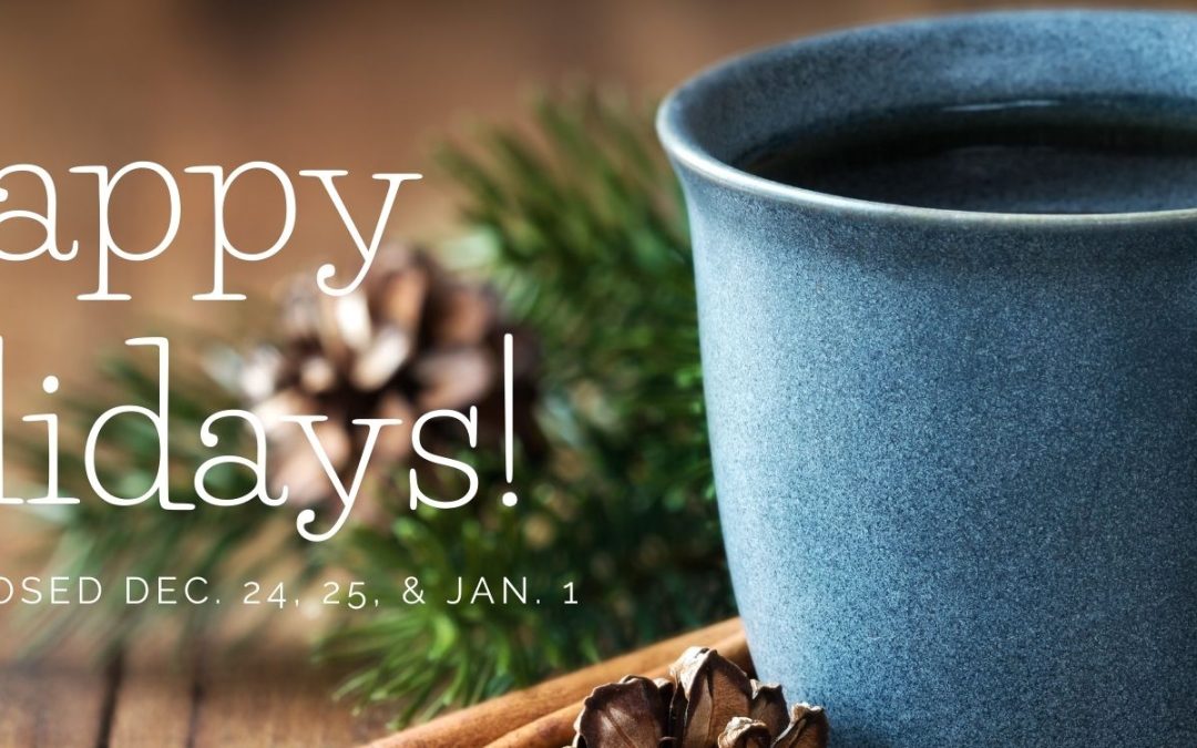 Blue ceramic mug with holiday decorations and a text wishing Happy Holidays and the library's closed days December 24, 25 and January 1