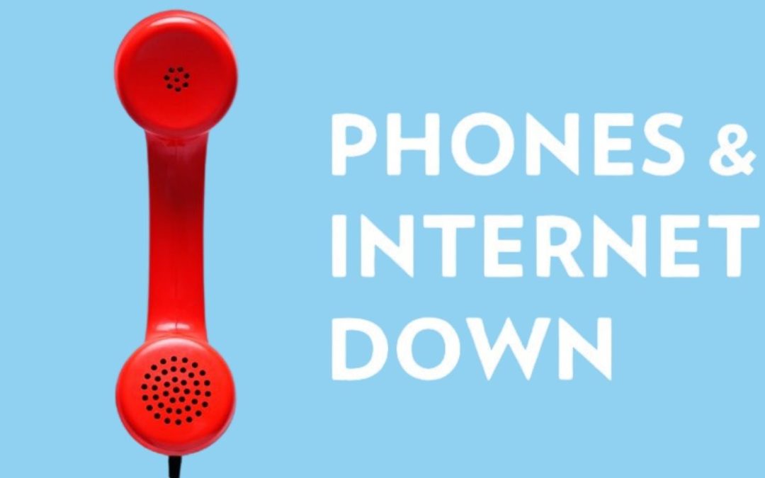 Red vintage telephone handset on a blue background with the text "PHONES & INTERNET DOWN."