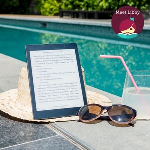 A tablet on a straw sunhat beside sunglasses and a drink by a swimming pool, with a character graphic saying "Meet Libby" in the corner.